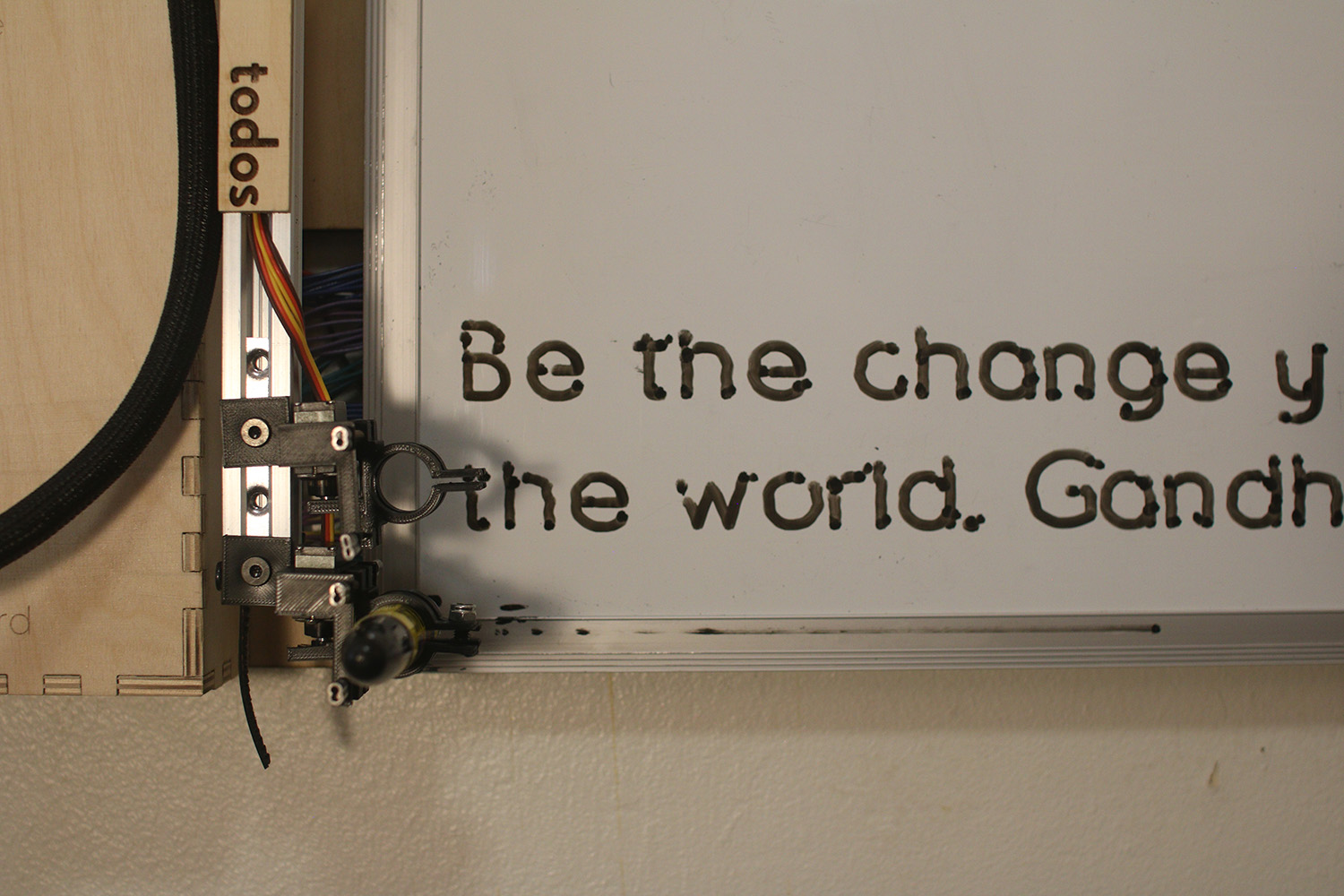 Close-up of the board shows the marker near a quote it's written. 'Be the change you wish to see in the world' can be partially seen.